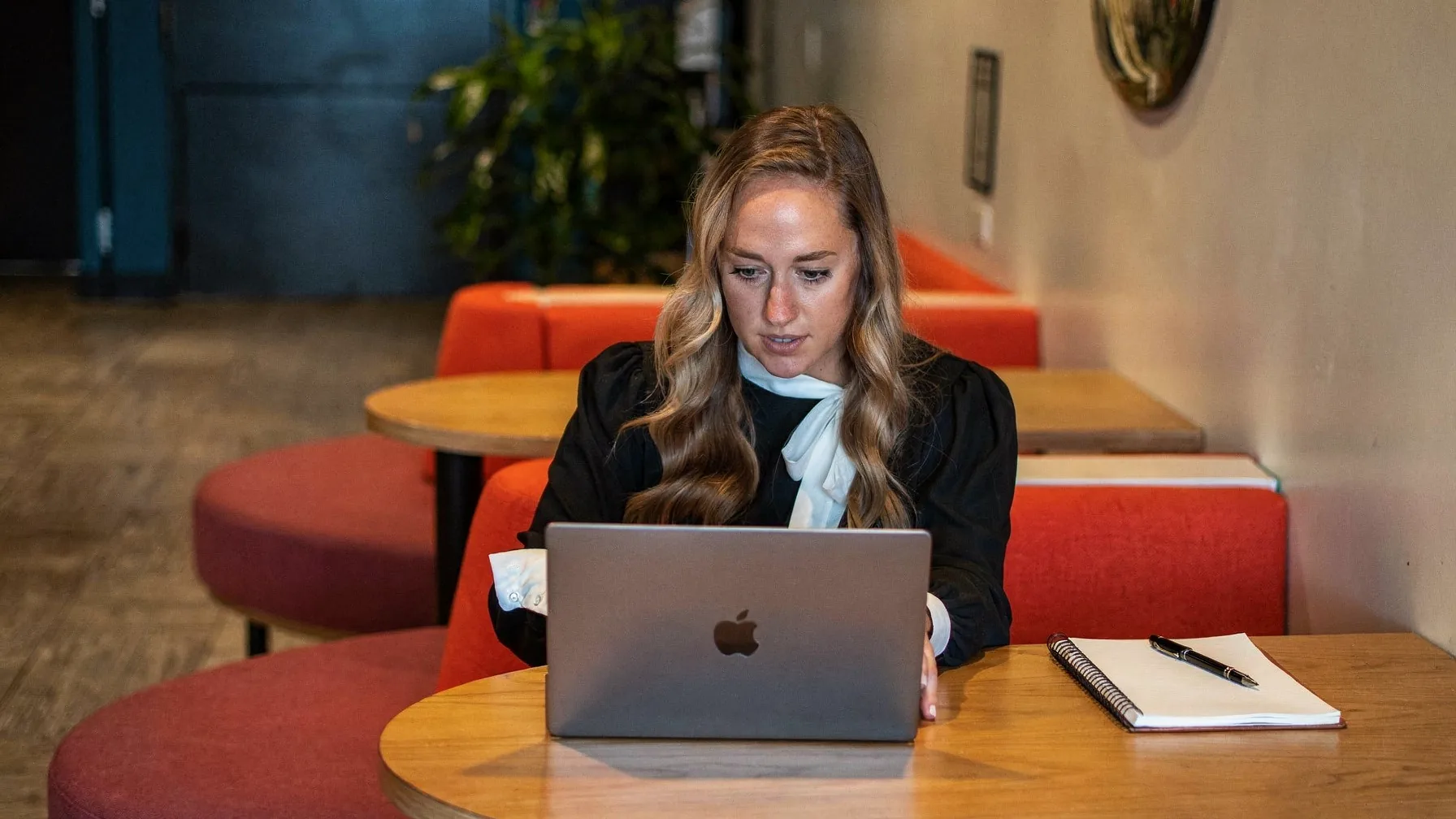 Looking up a provider's licence on a laptop with a notepad alongside