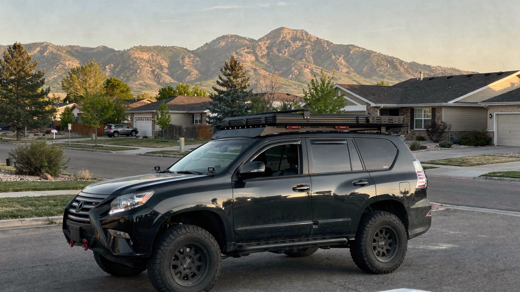 A mobile IV service vehicle on a Broomfield street with the Front Range foothills behind it